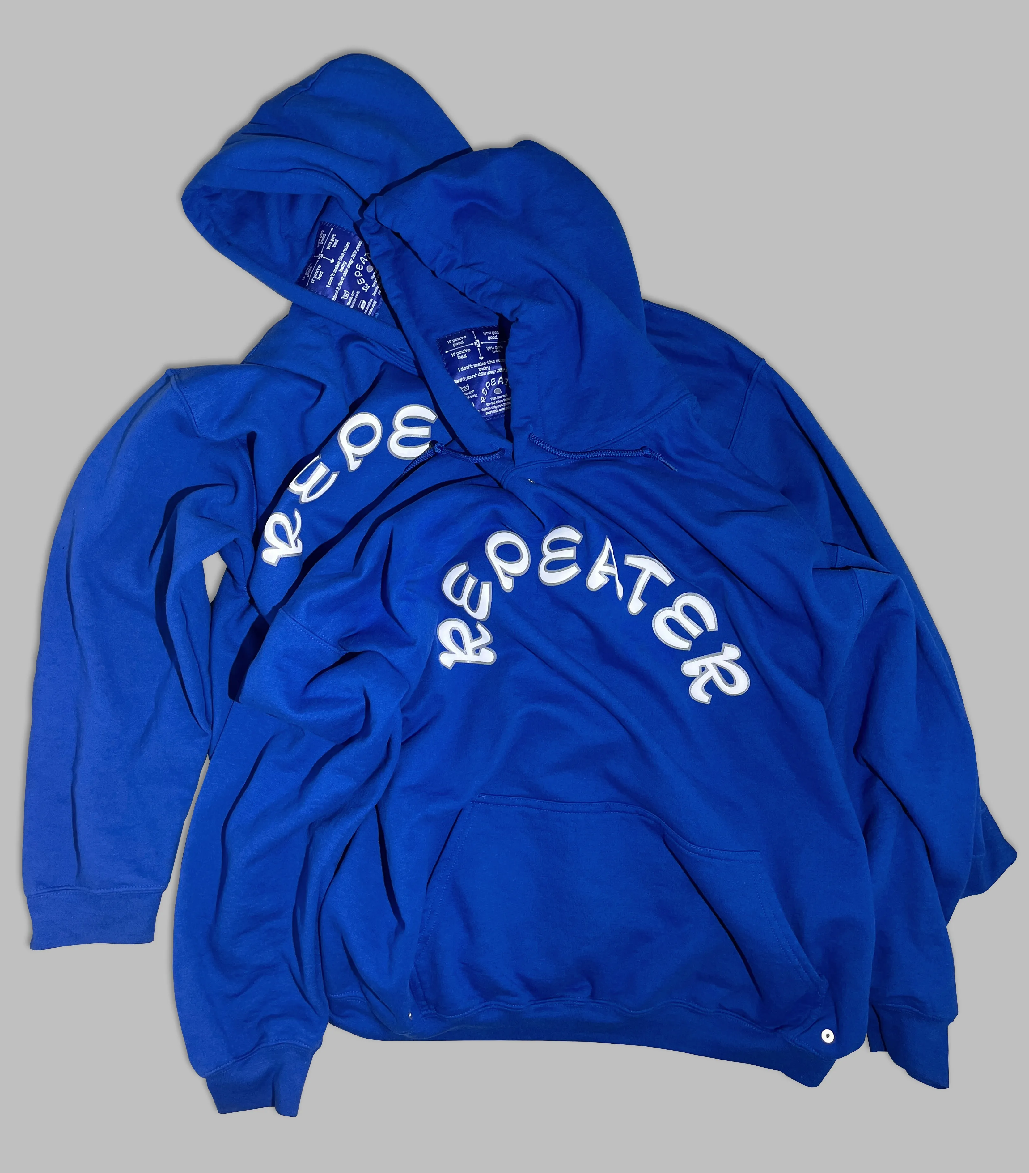 Two bloue hoodies, with the word repeater printed on the front